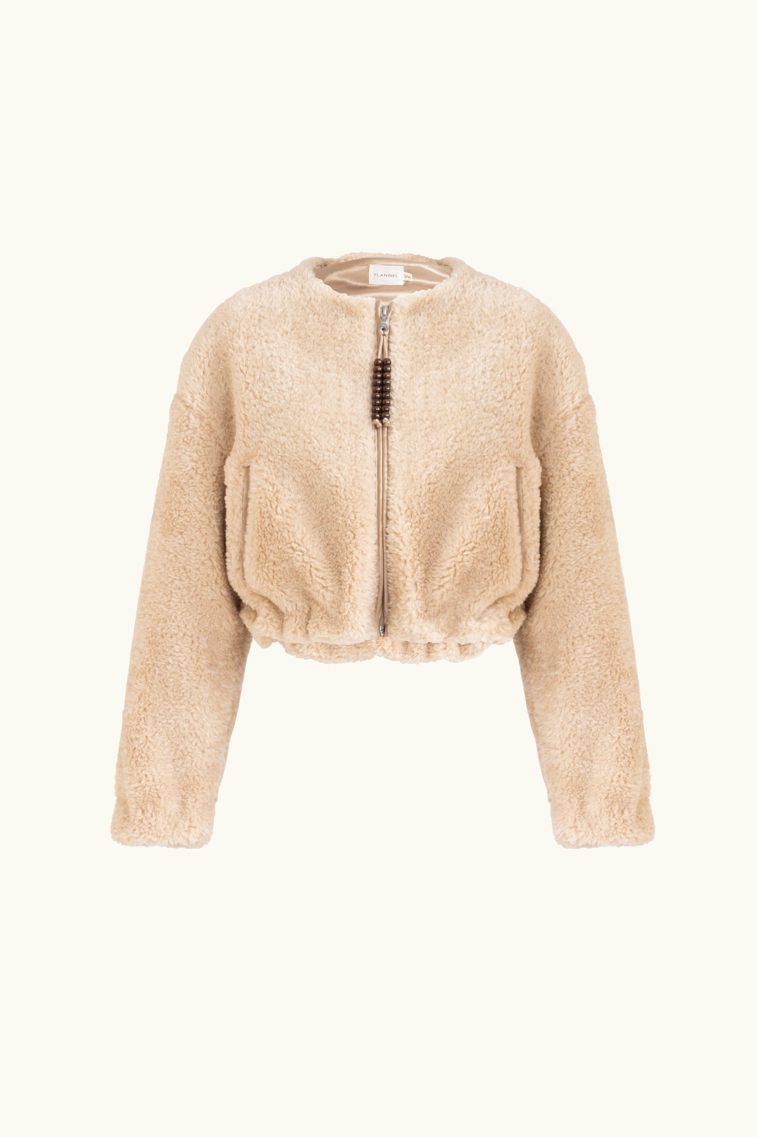Oat faux fur jacket with beaded tassels on a white background
