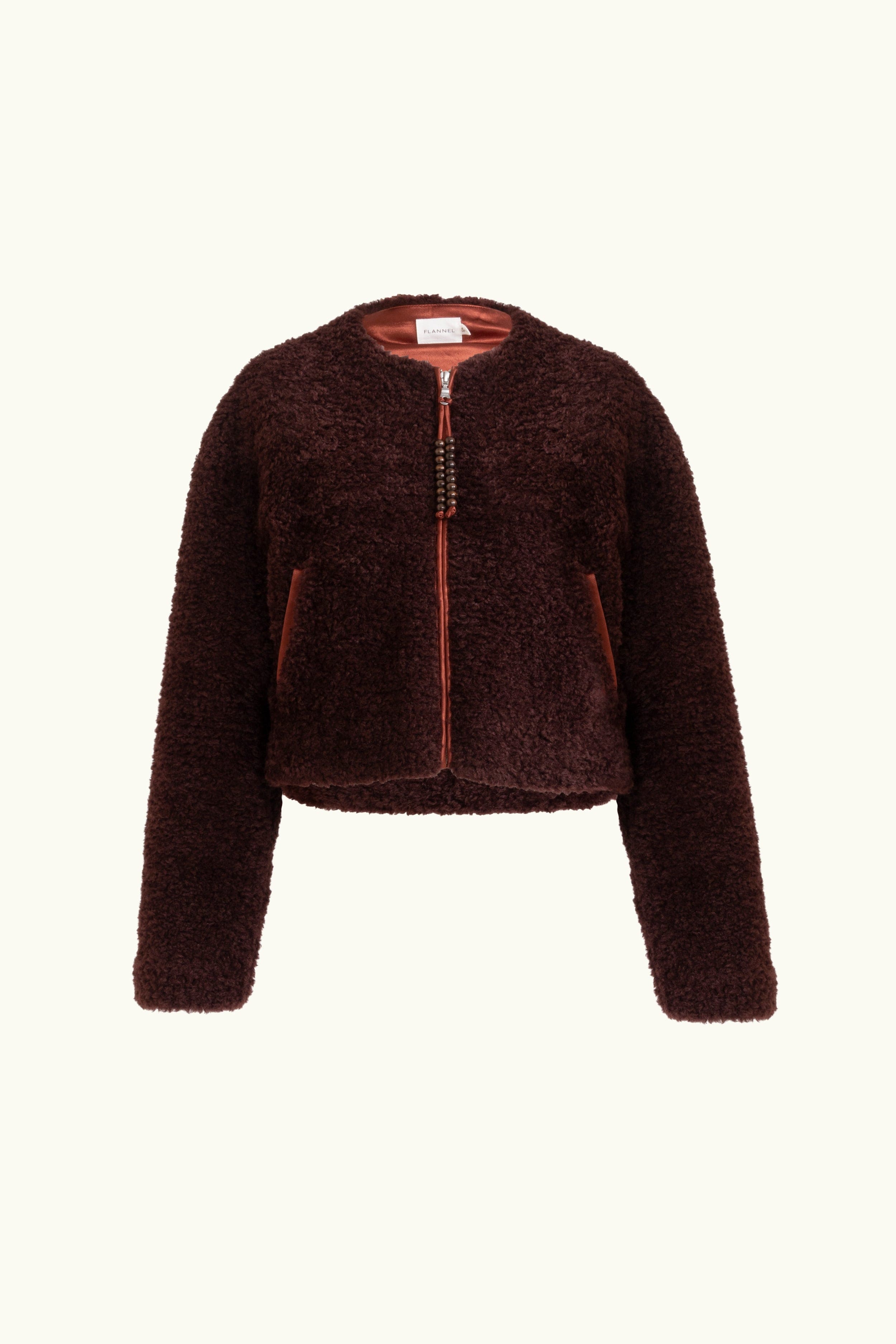 Faux fur port jacket with beaded zip up tassels on a white background