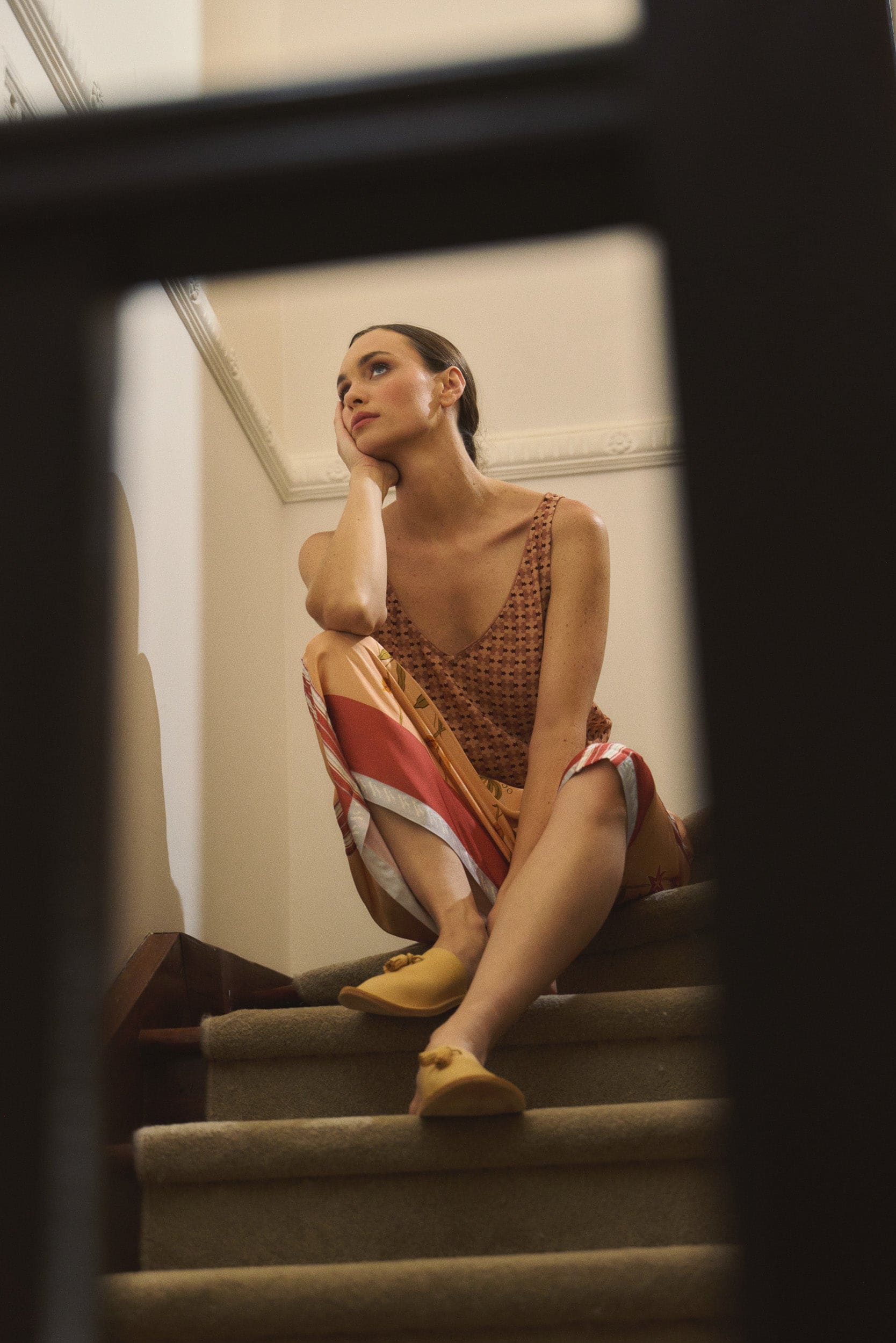 Model wearing peach print tank and print skirt, campaign image