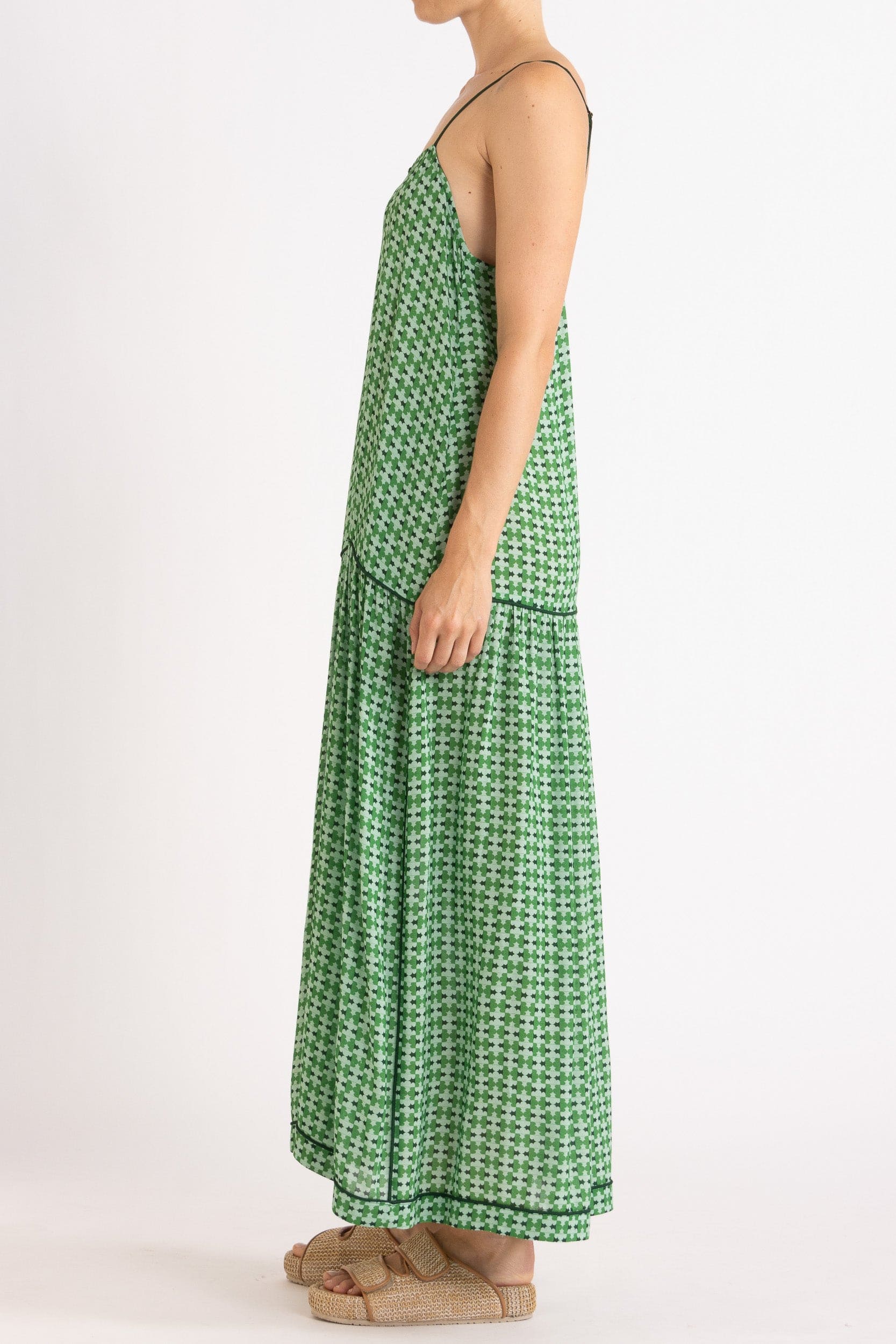 Model wearing green patterned dress, side view