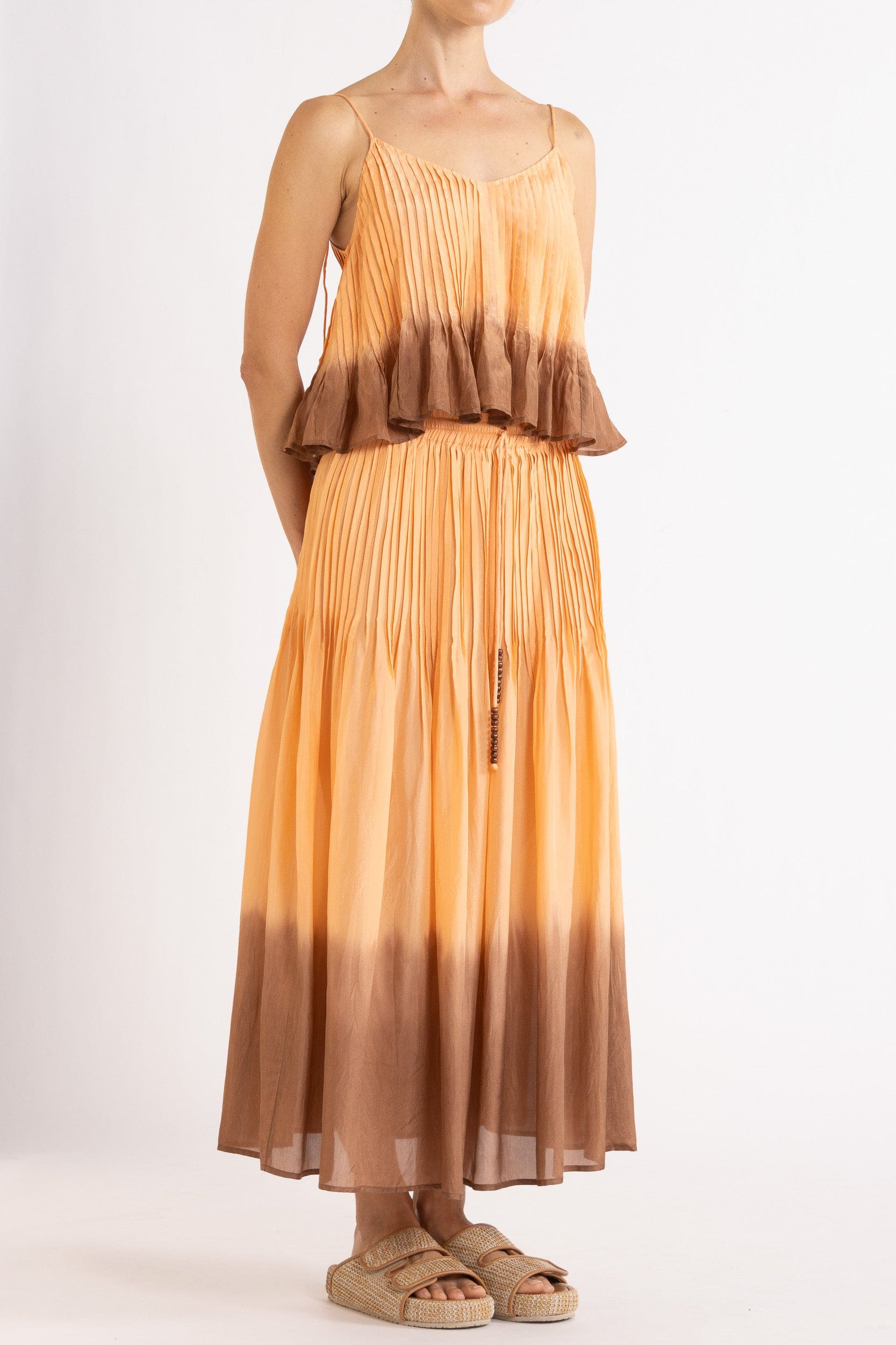 Model wearing peach dip-dye silk cami & skirt, front-side view