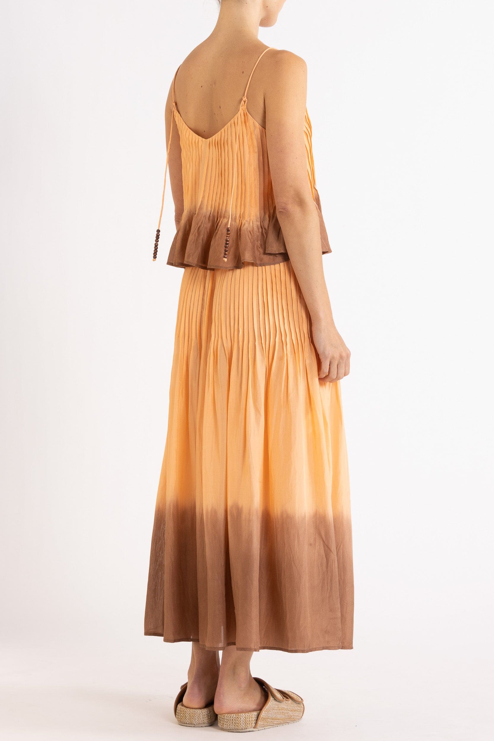 Model wearing peach dip-dye silk cami & skirt, back-side view