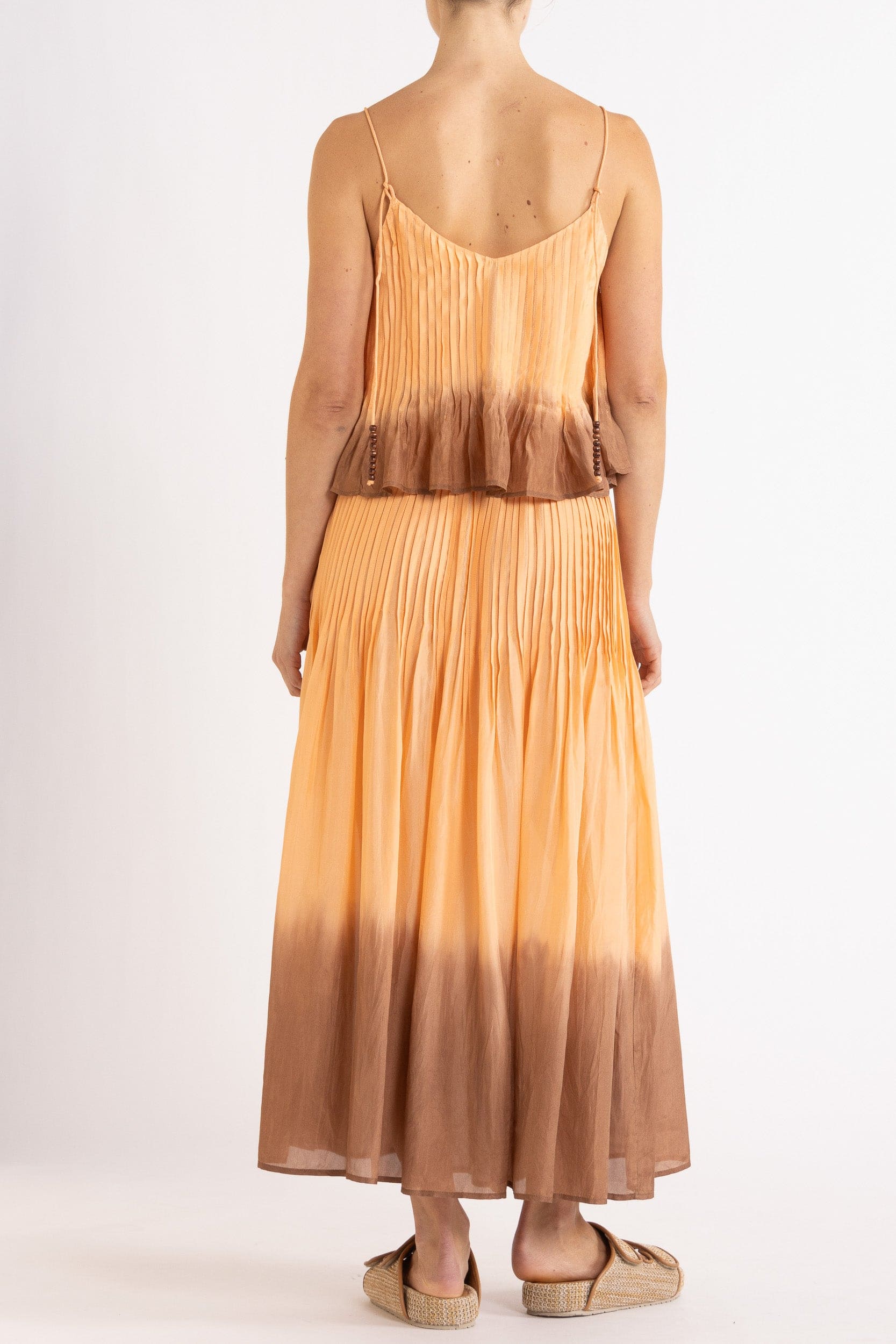 Model wearing peach dip-dye silk cami & skirt, back view