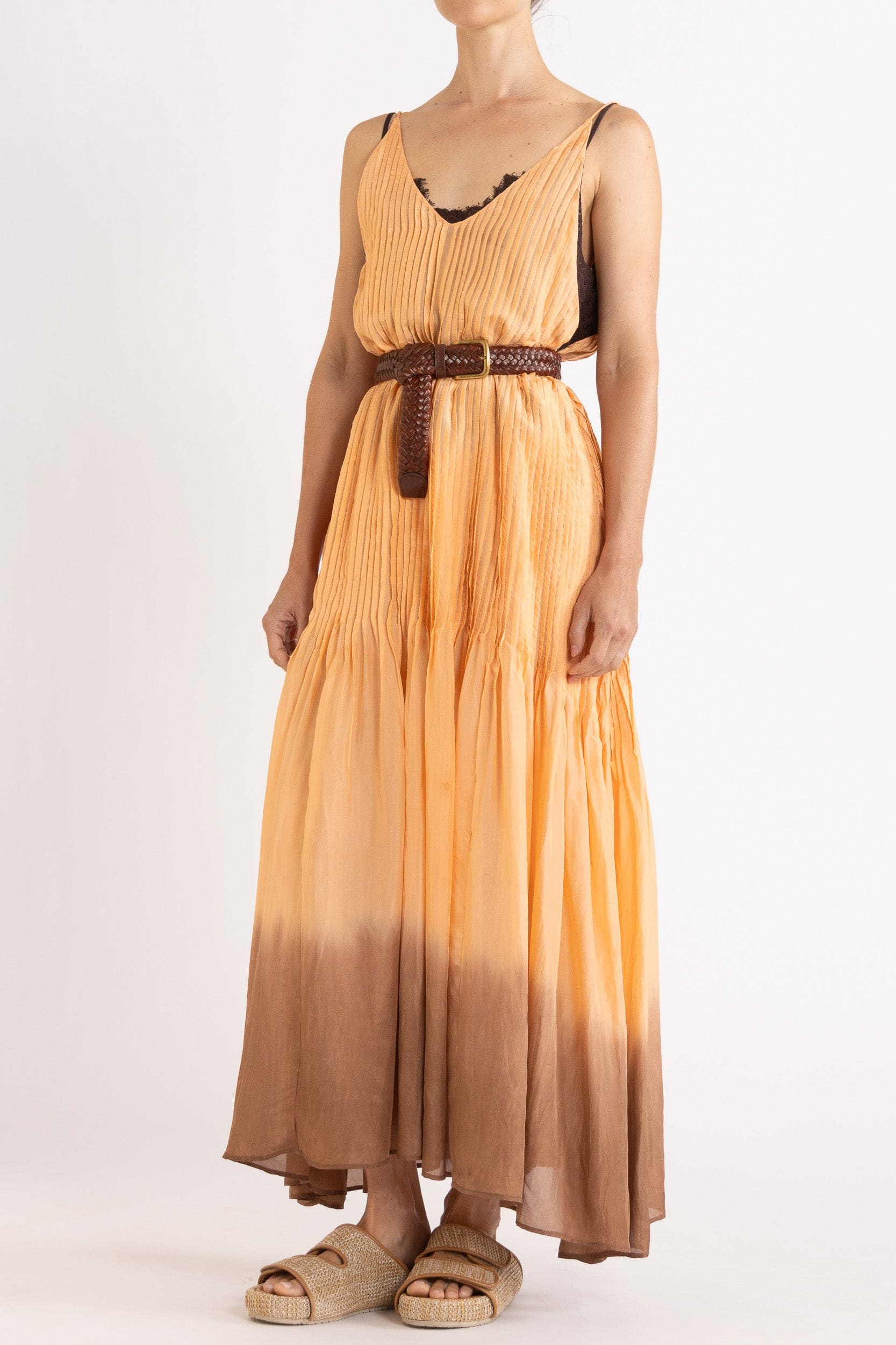 Model wearing peach dip-dye silk cami dress & brown plaited leather belt, front-side view