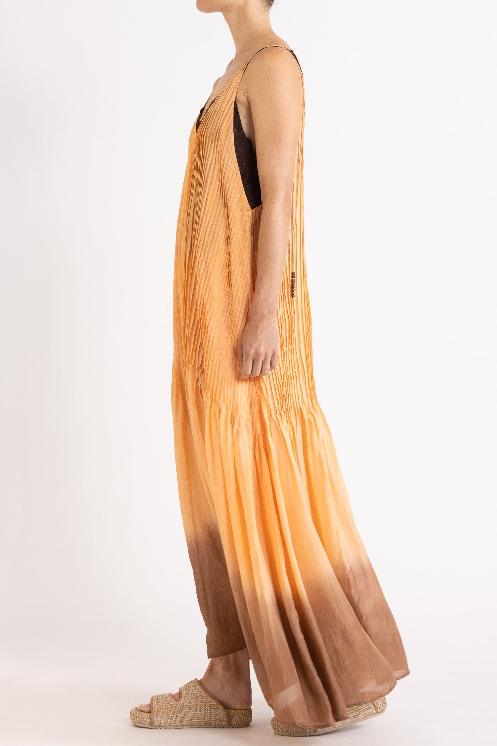 Model wearing peach dip-dye silk cami dress, side view
