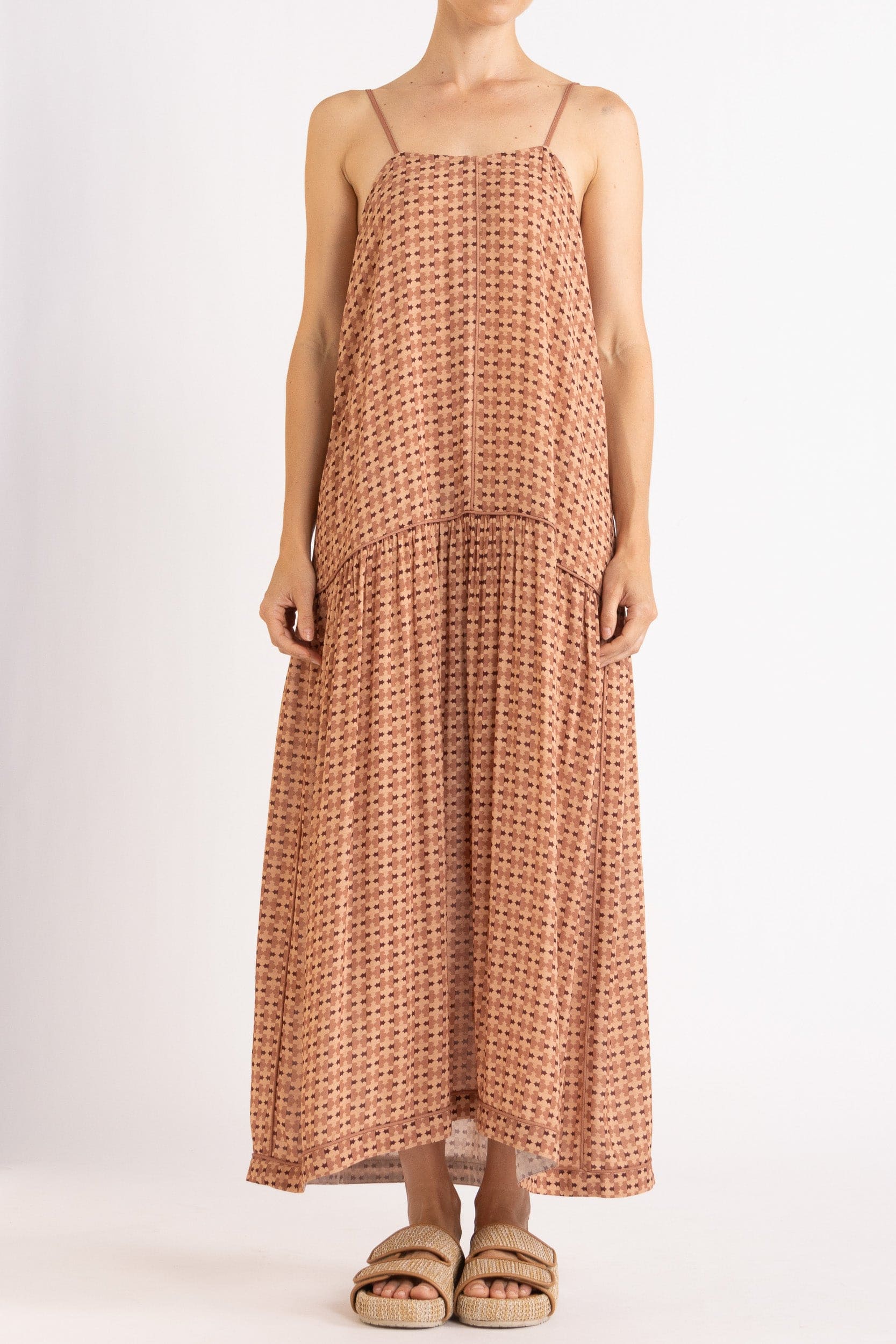 Model wearing peach patterned dress, front view