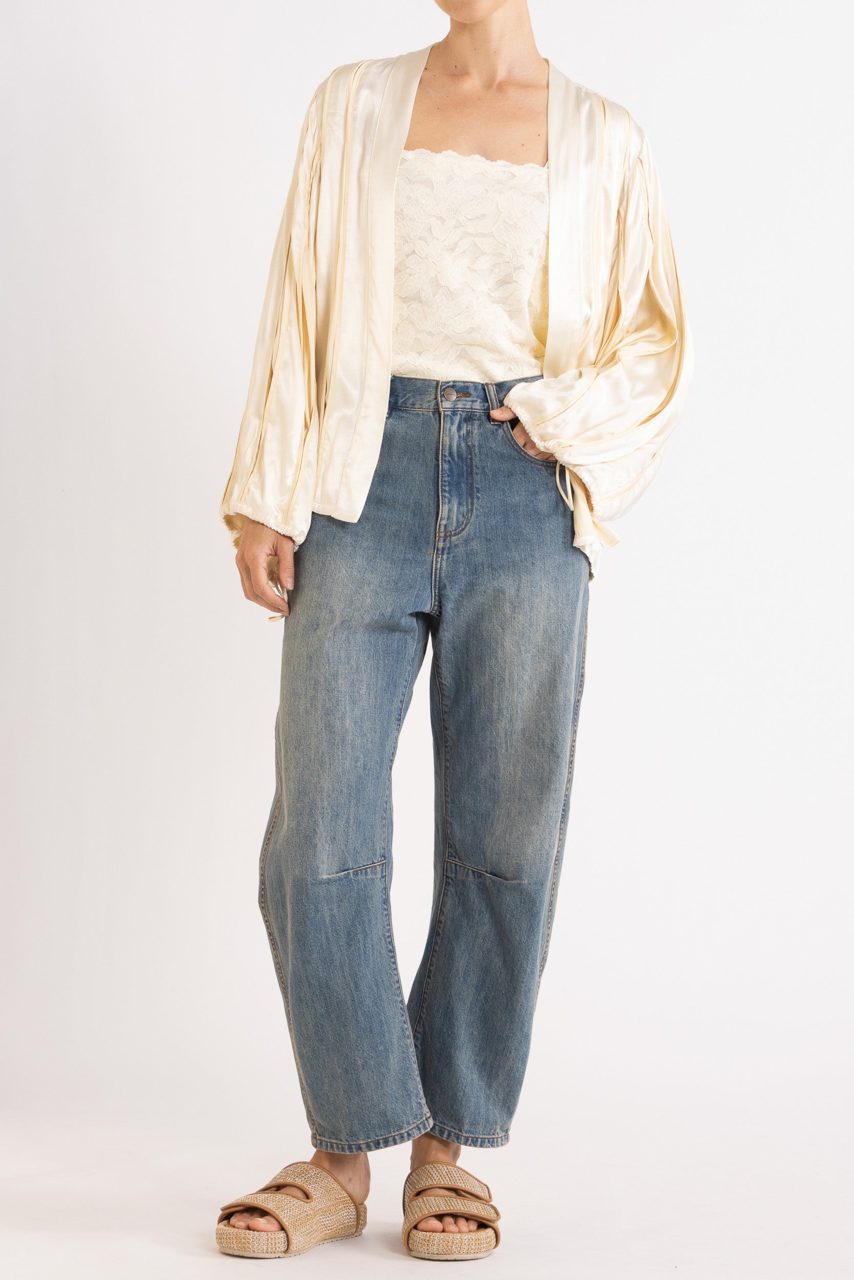 Model wearing cream box pleat jacket, white lace camisole & denim jean, front view
