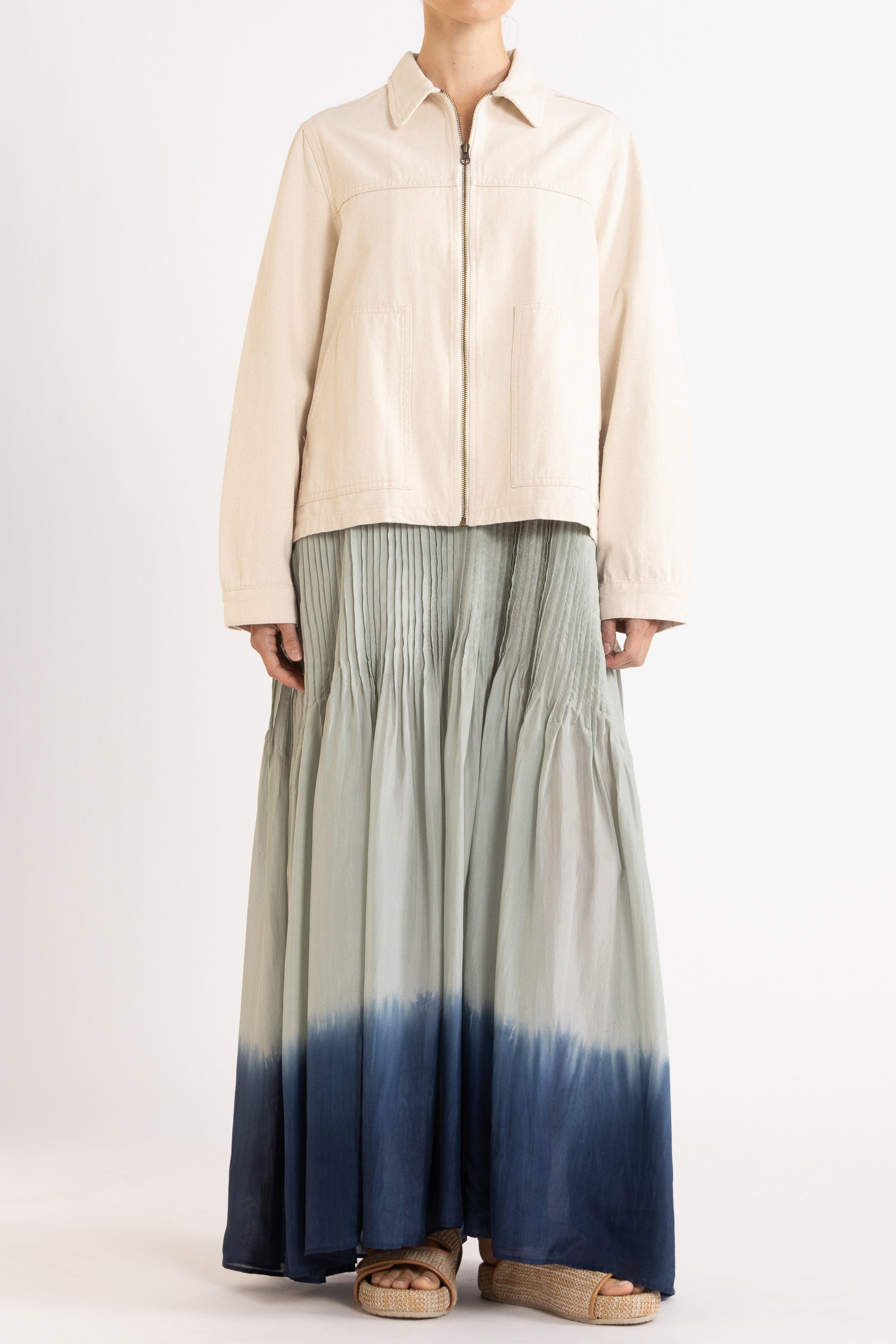 Model wearing cream cotton-twill utility jacket & sky blue dip-dye silk dress, front view