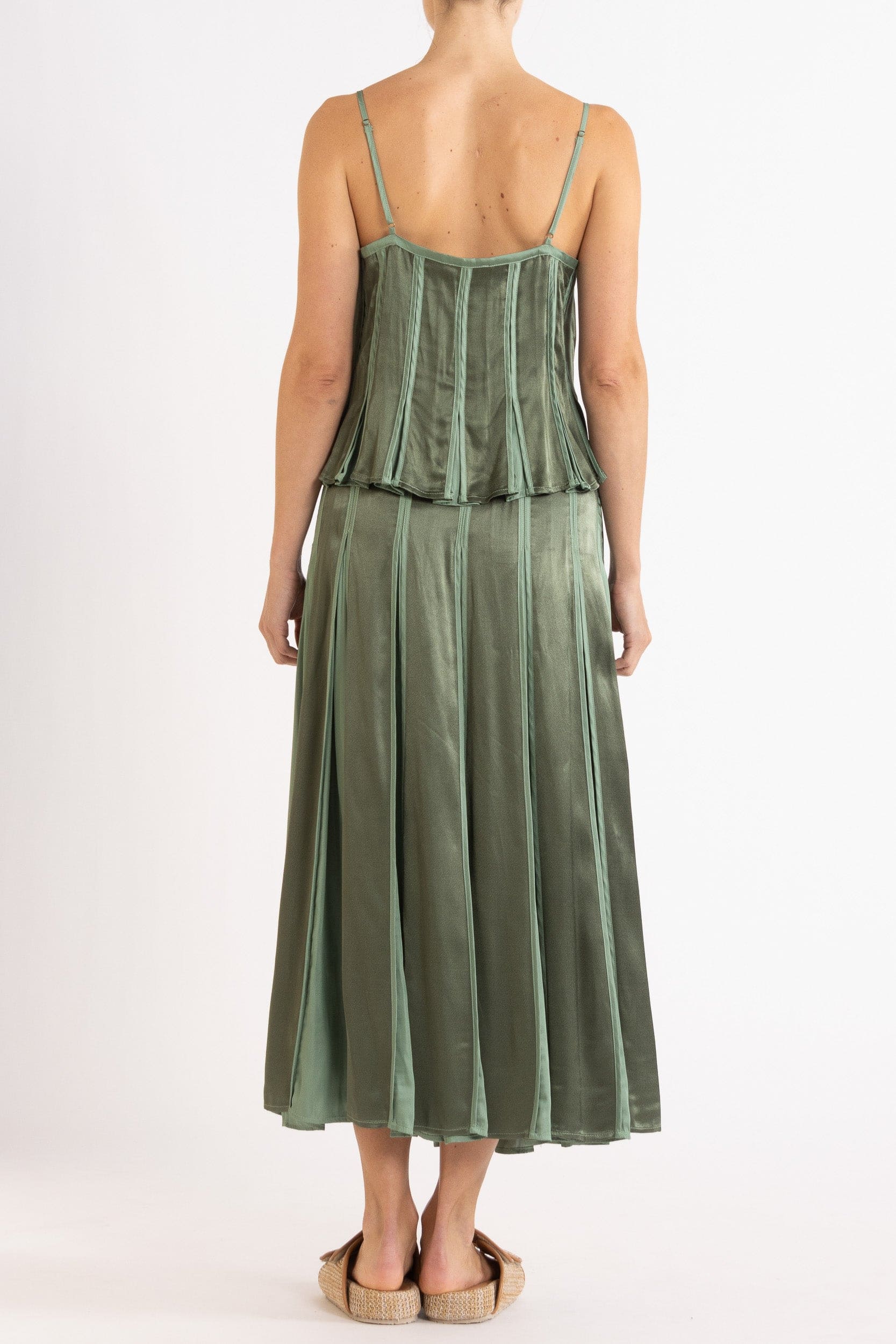 Model wearing olive green box pleat camisole & skirt, back view