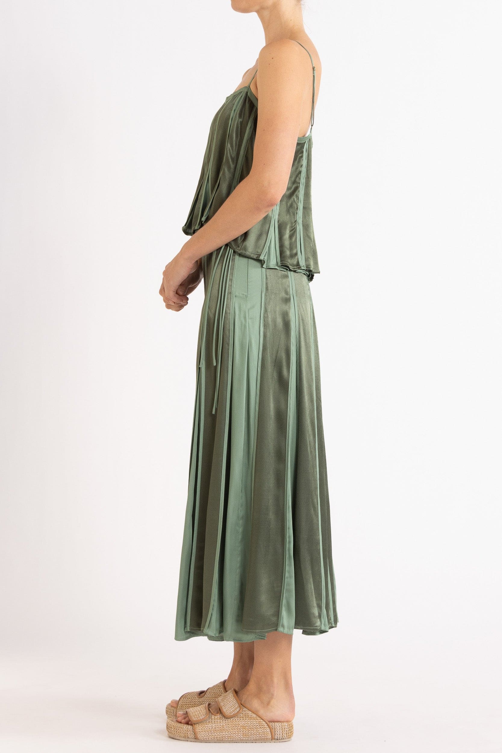 Model wearing olive green box pleat camisole & skirt, side view