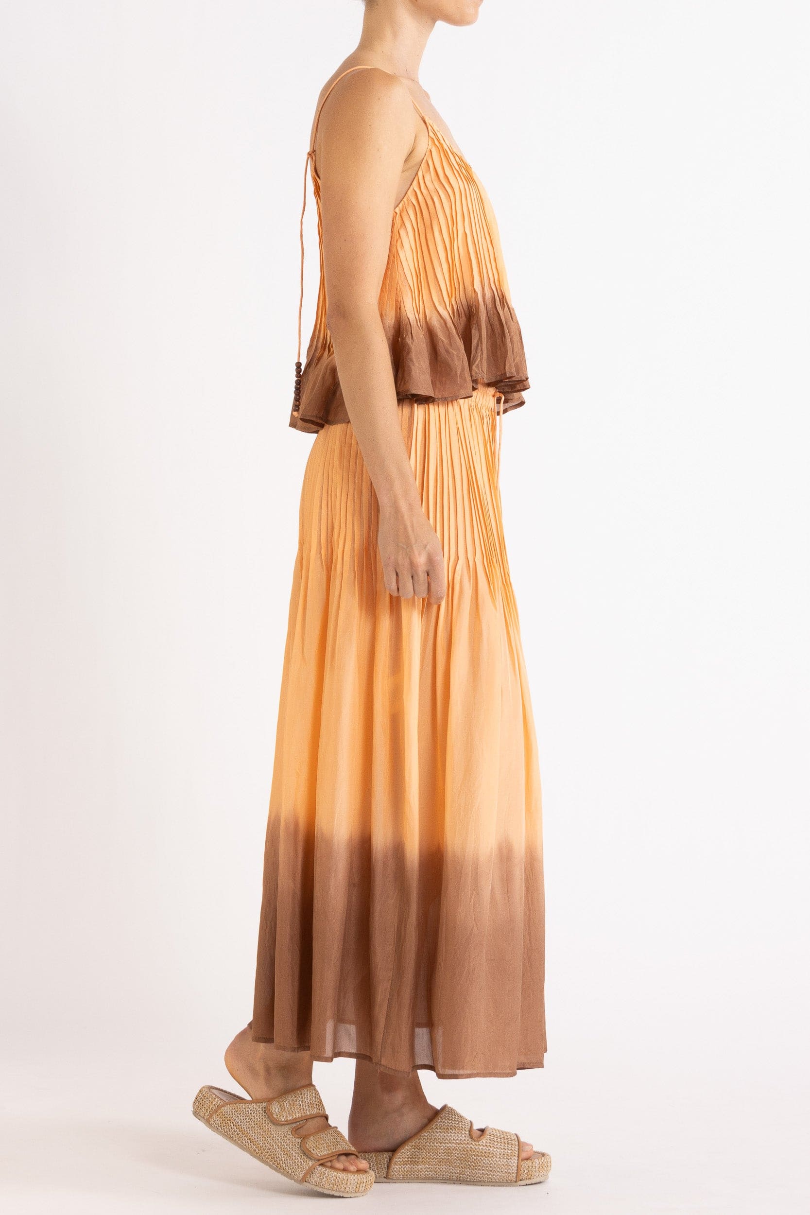 Model wearing peach dip-dye silk cami & skirt, side view