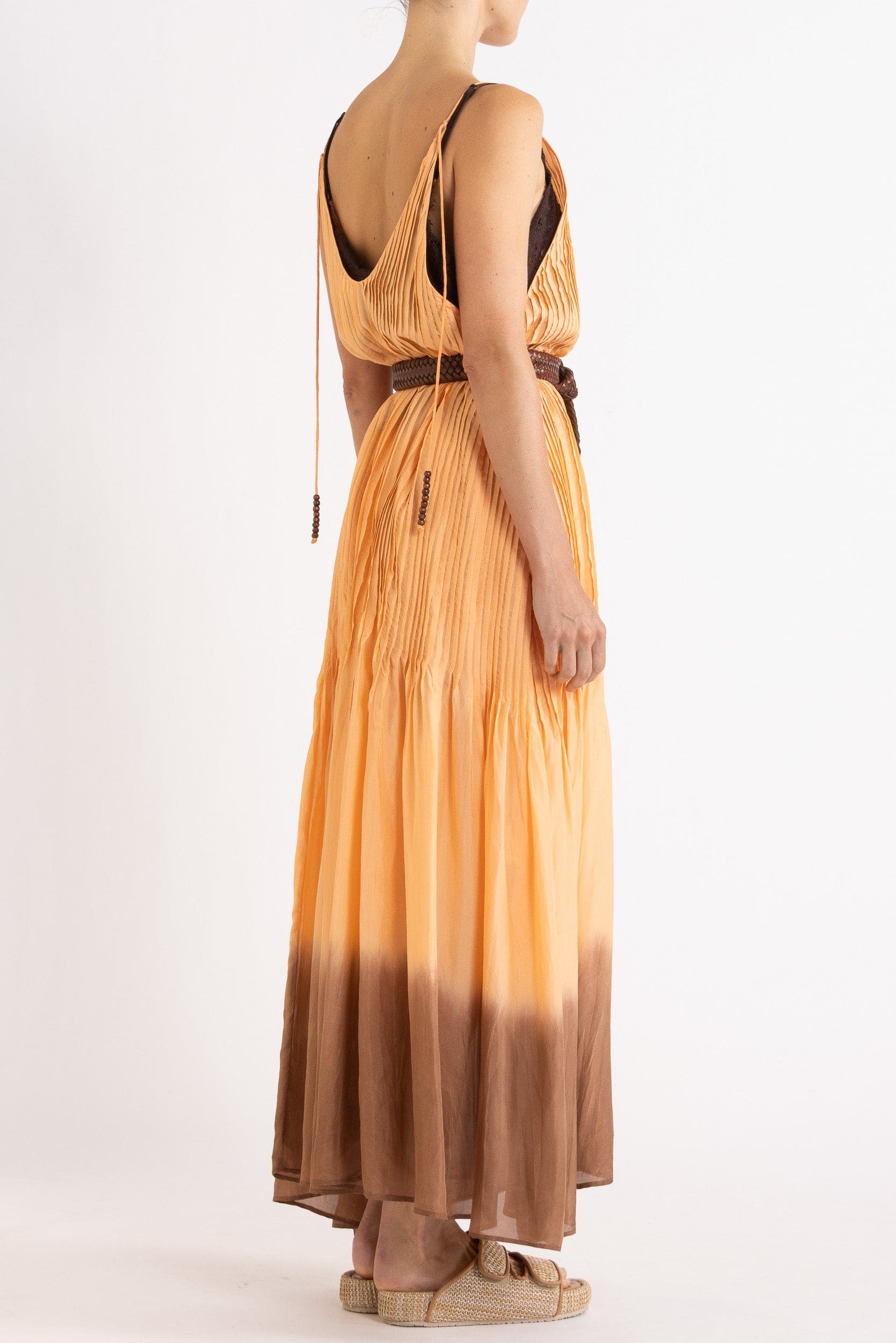 Model wearing peach dip-dye silk cami dress & brown plaited leather belt, back-side view