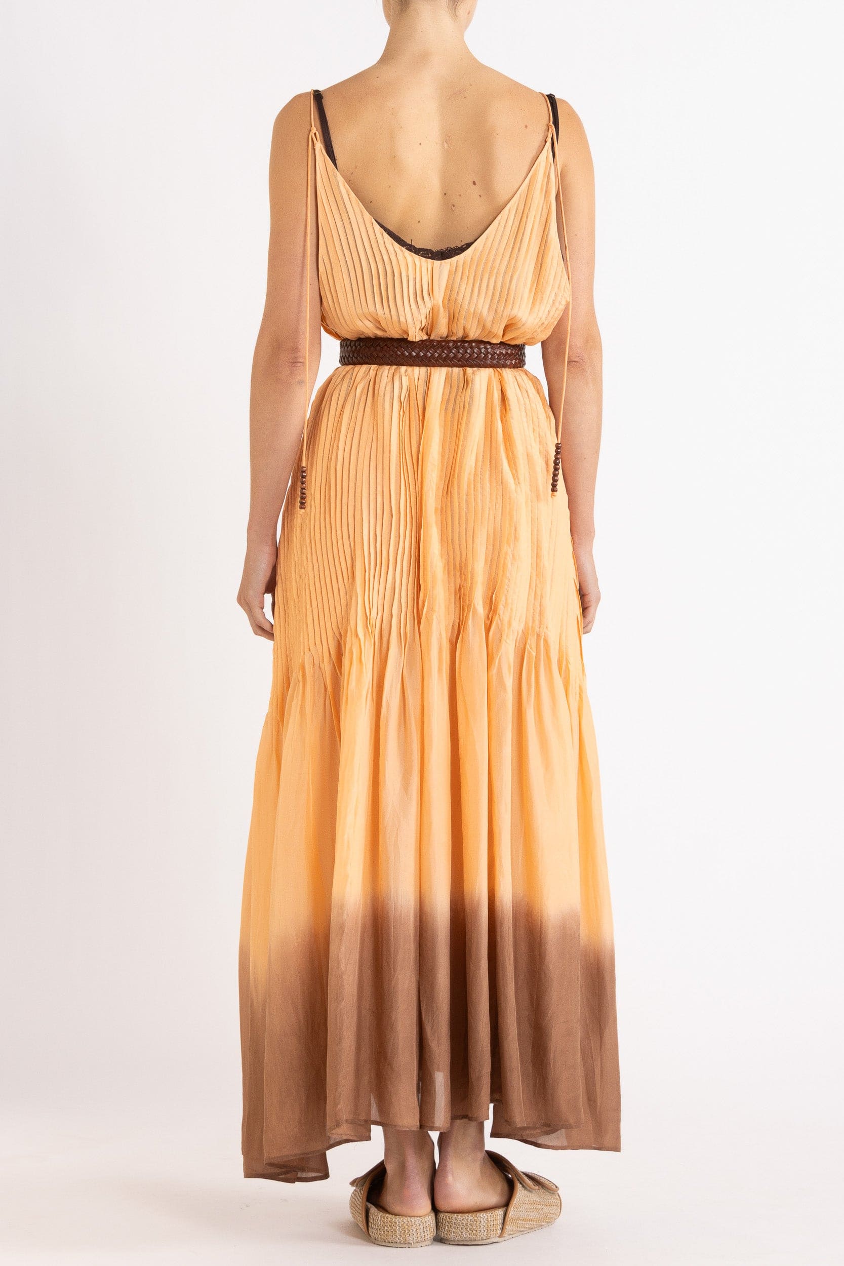 Model wearing peach dip-dye silk cami dress & brown plaited leather belt, back view