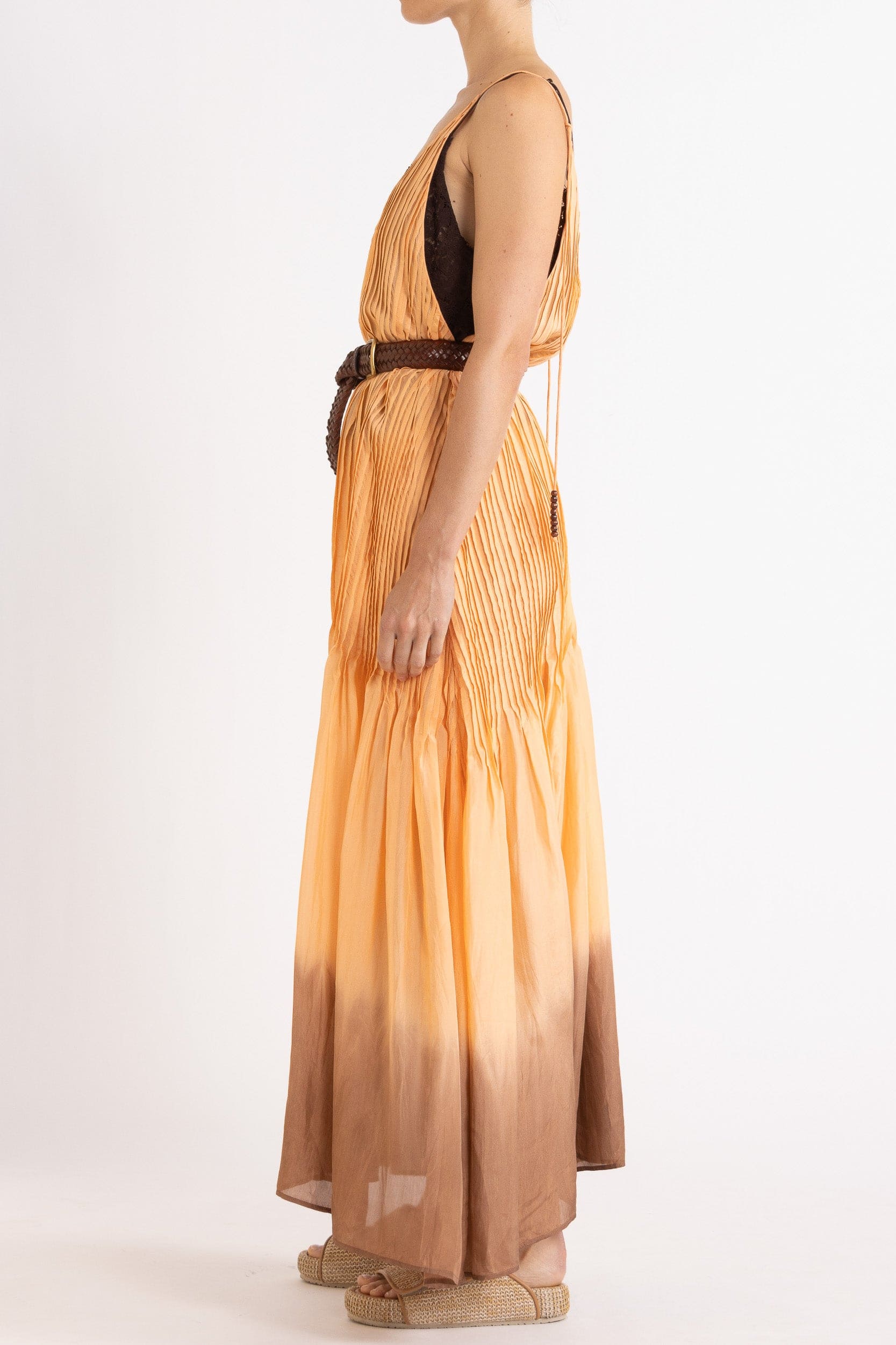 Model wearing peach dip-dye silk cami dress & brown plaited leather belt, side view