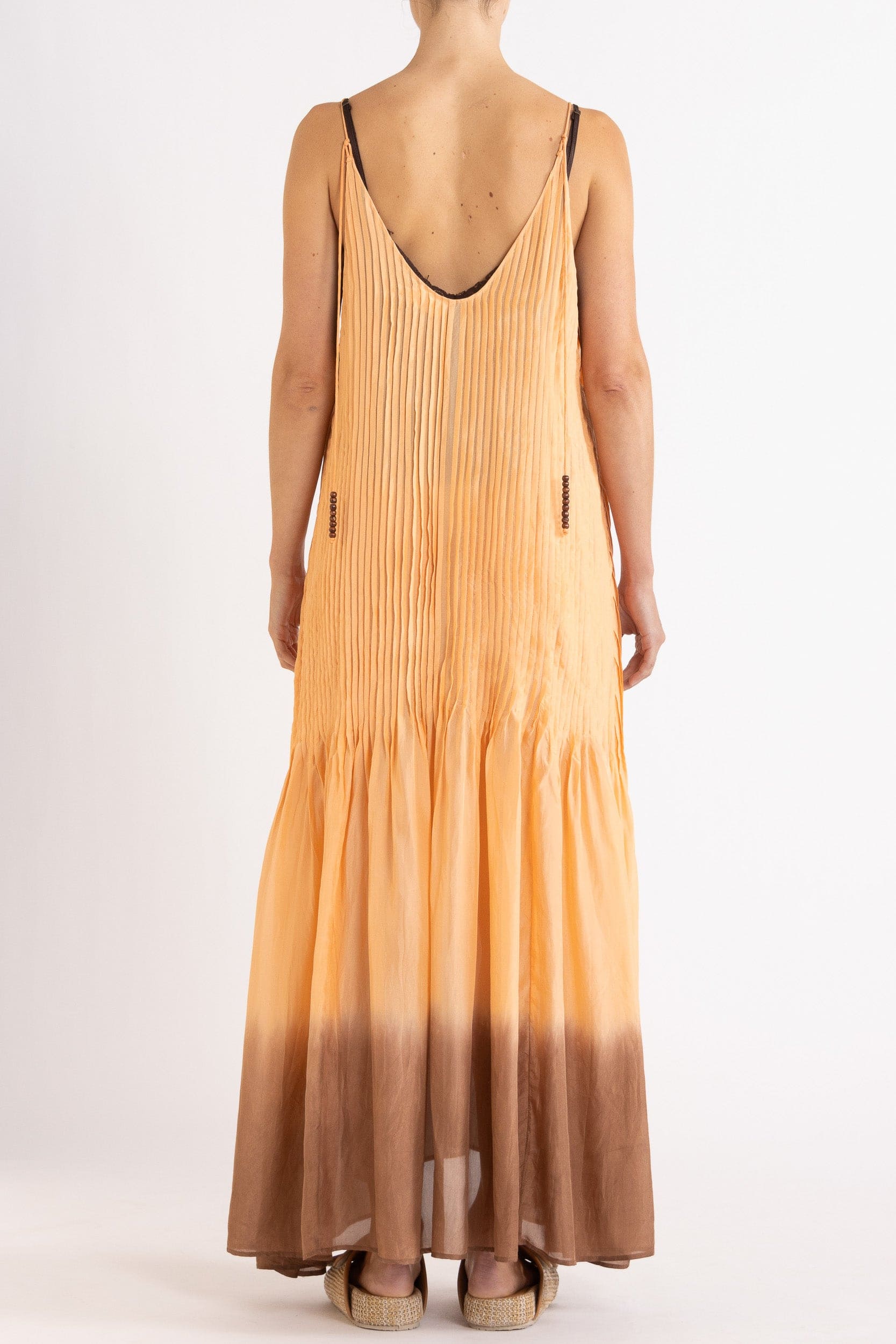 Model wearing peach dip-dye silk cami dress, back view
