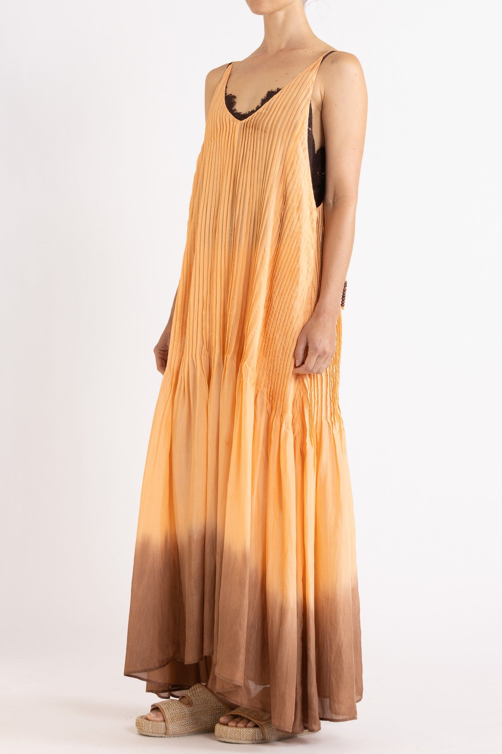 Model wearing peach dip-dye silk cami dress, front-side view