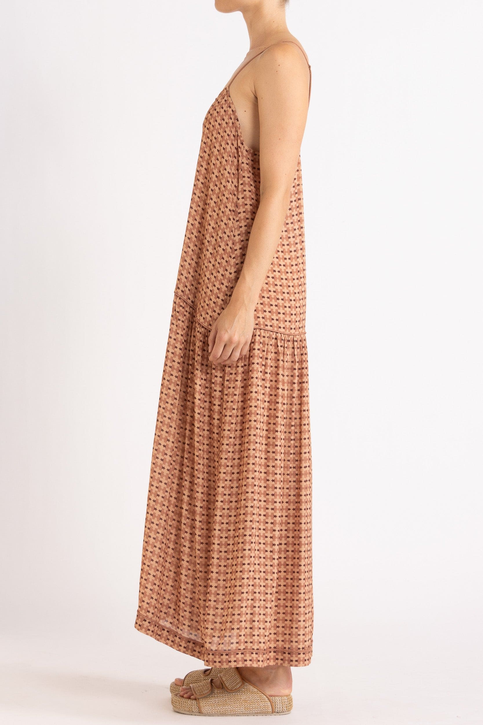 Model wearing peach patterned dress, side view