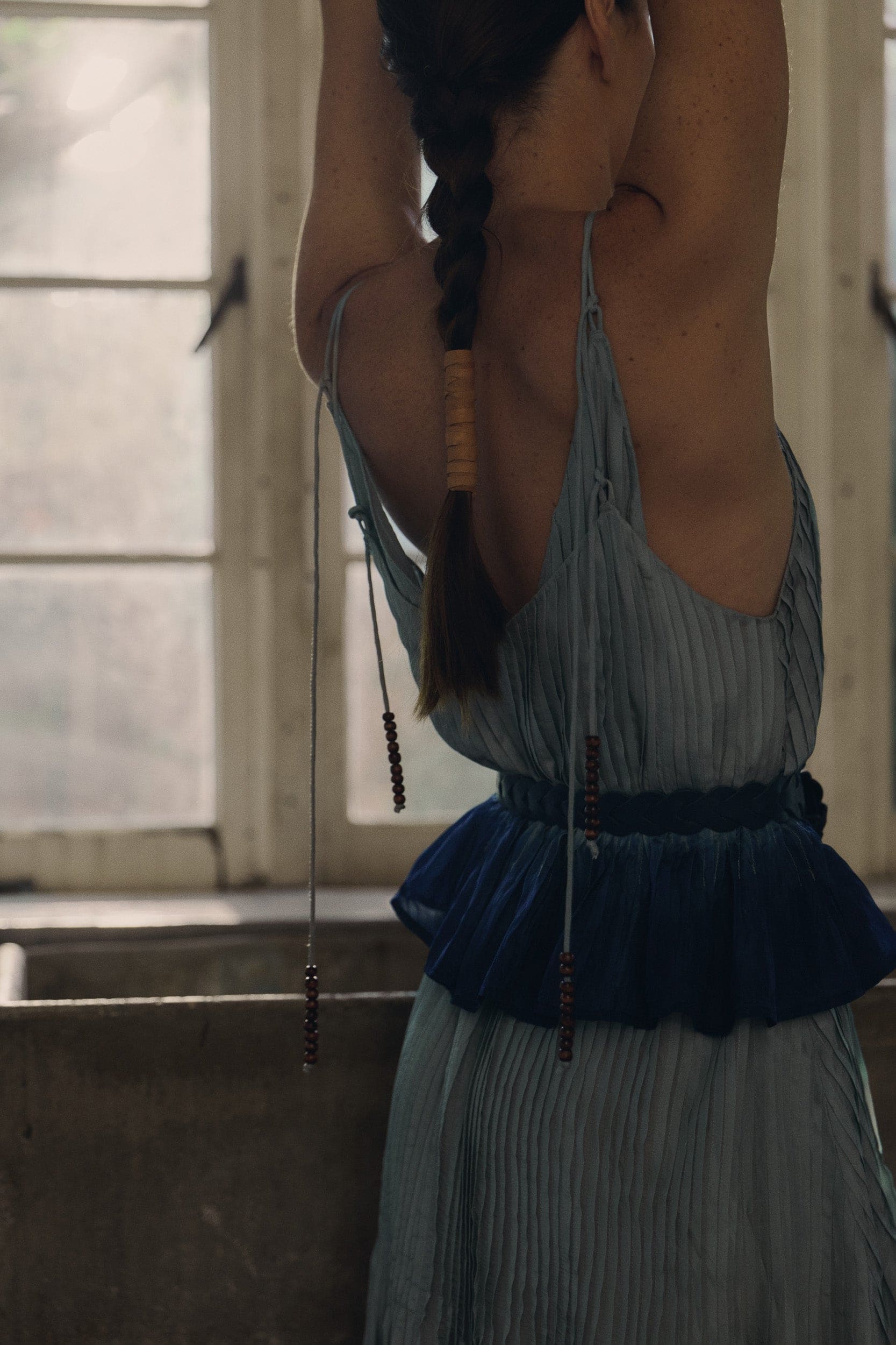 Model wearing sky blue silk cami & dress, campaign image close up