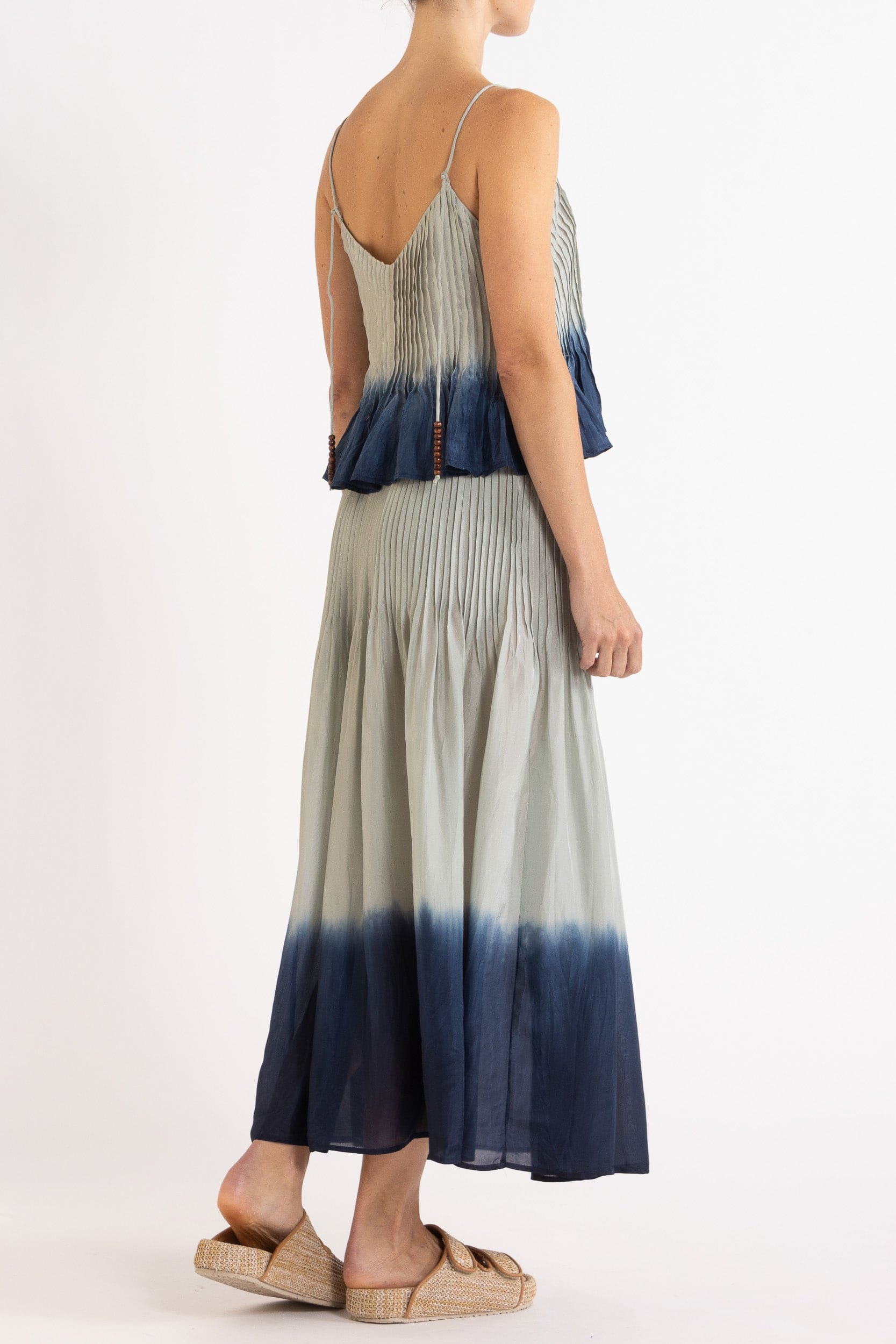 Model wearing sky blue dip-dye silk cami & skirt, back-side view