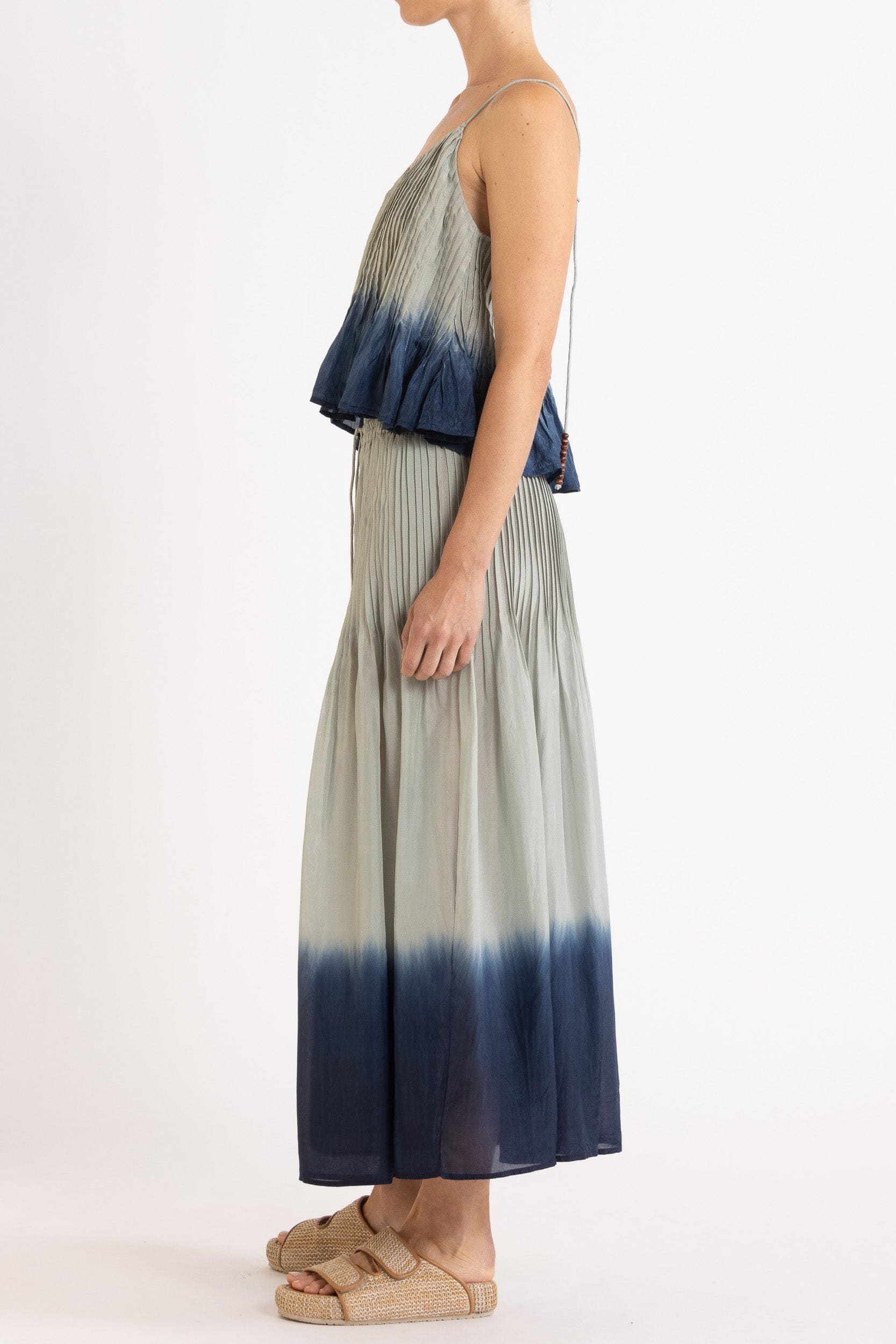 Model wearing sky blue dip-dye silk cami & skirt, side view